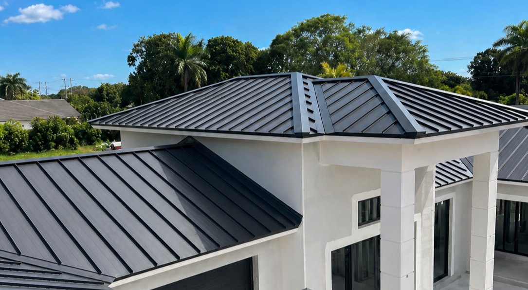 Modern South Florida home with a standing-seam metal roof by SafeTech Builders