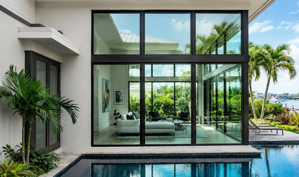 Modern South Florida home with floor-to-ceiling hurricane impact glass by SafeTech Builders